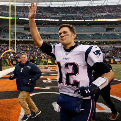 Tom Brady waving at the fans after a NFL game.